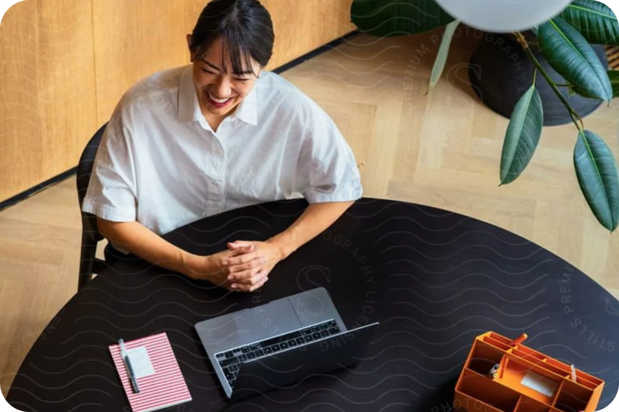 Closer overhead crop of one colleague smiling at the same table