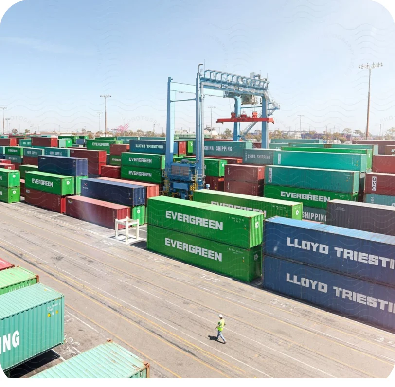 Stacked shipping containers at a port terminal seen from above