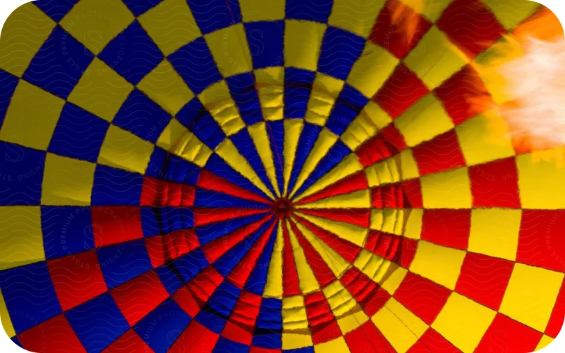 Looking up into the canopy of a red, yellow and blue hot-air balloon