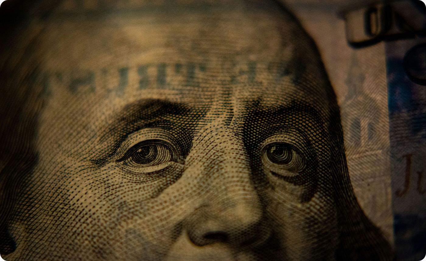 A United States one hundred dollar bill, representing fraud and anti-money laundering investigation