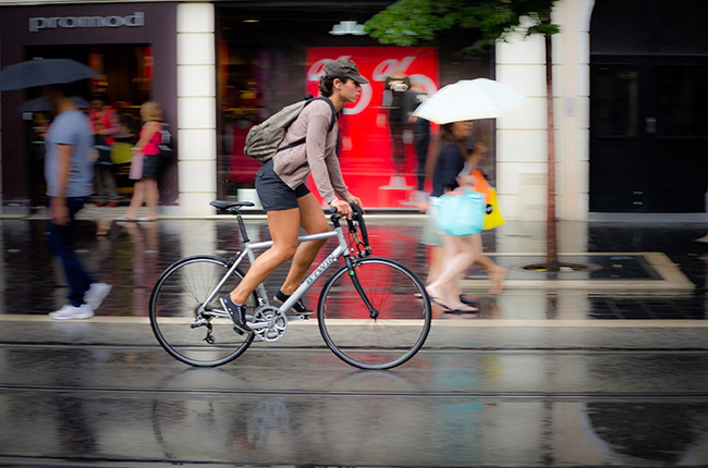 Woman riding a bicycle in the rain. 